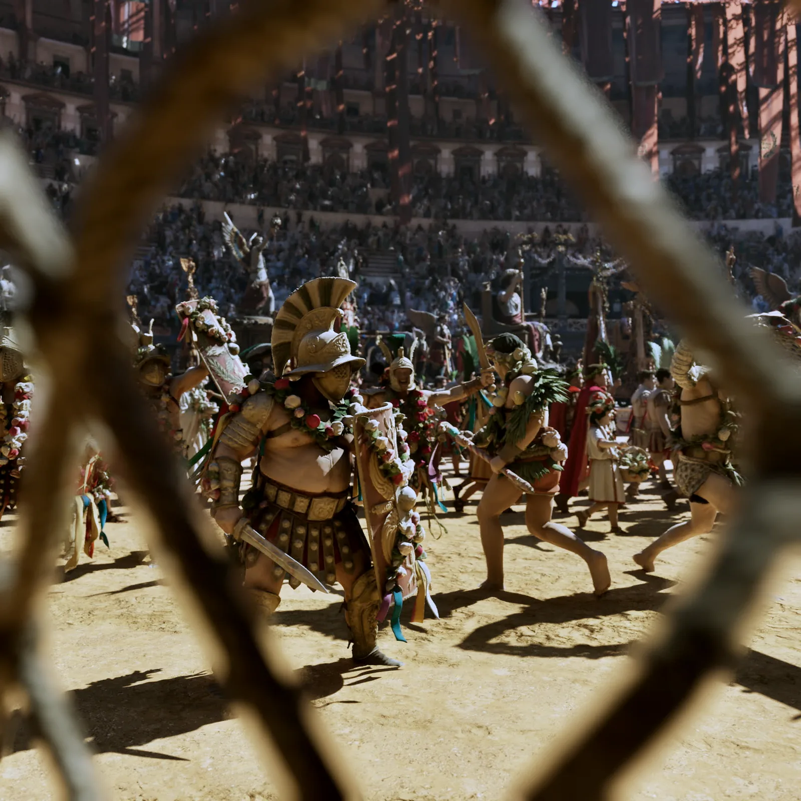 The opening procession of the games crossing the arena, seen through the lattice of a cage below the stands.